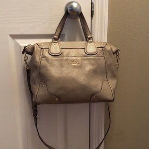 Coach gold/tan purse with cross body strap.